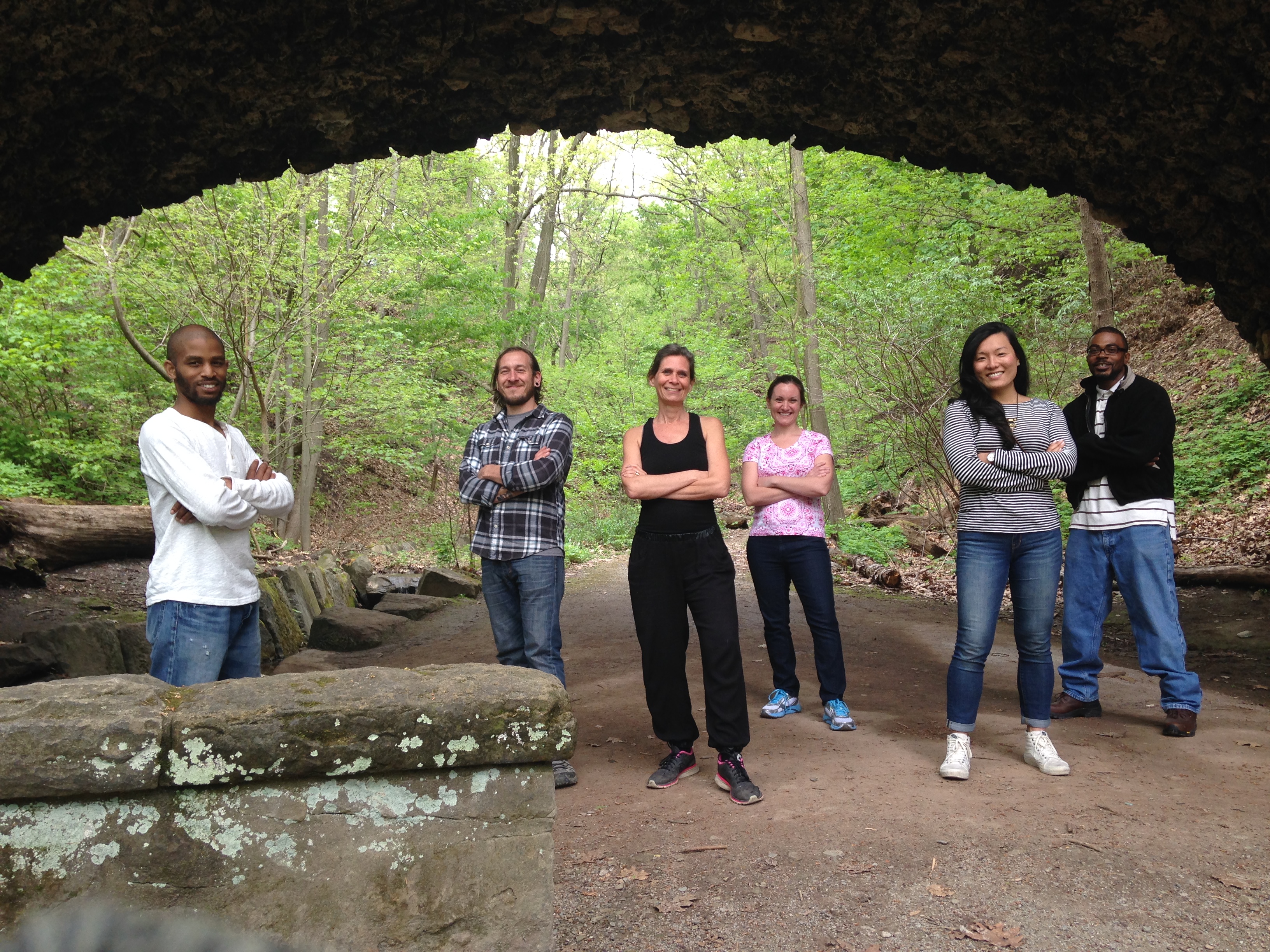 The Landforce staff standing under a bridge in Schenley Park.